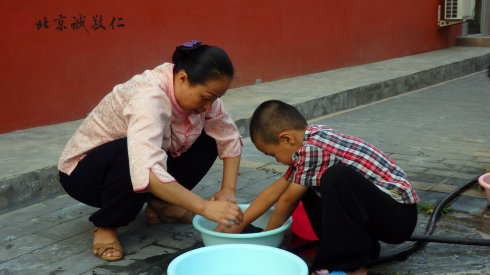 生活老師指導(dǎo)小學(xué)員洗衣服
