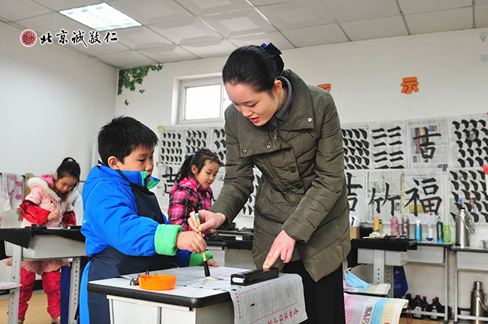 書法老師認(rèn)真指導(dǎo)小學(xué)員習(xí)書